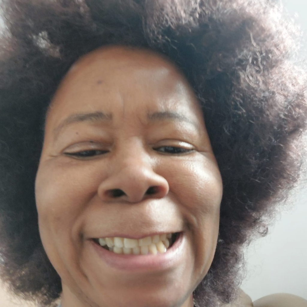 A black woman smiling at the camera